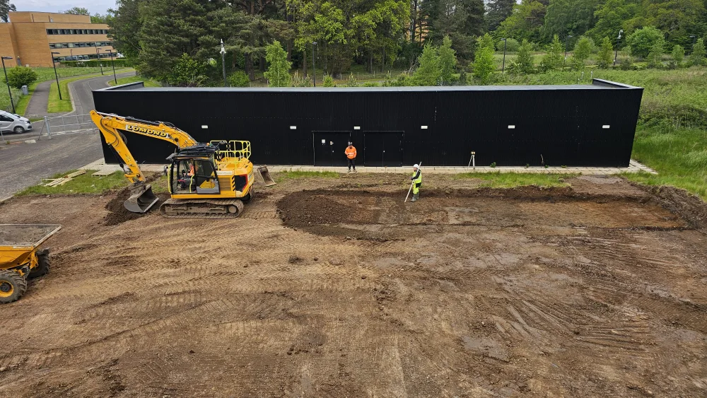 A digger and workmen at a construction site