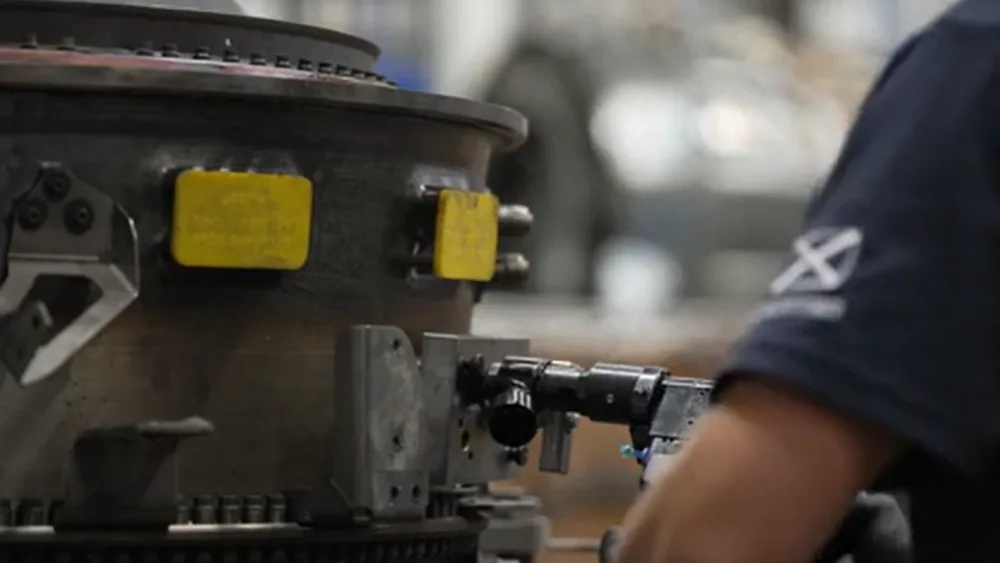 A GE Aerospace employee operated a piece of machinery. (GE Aerospace/PA)