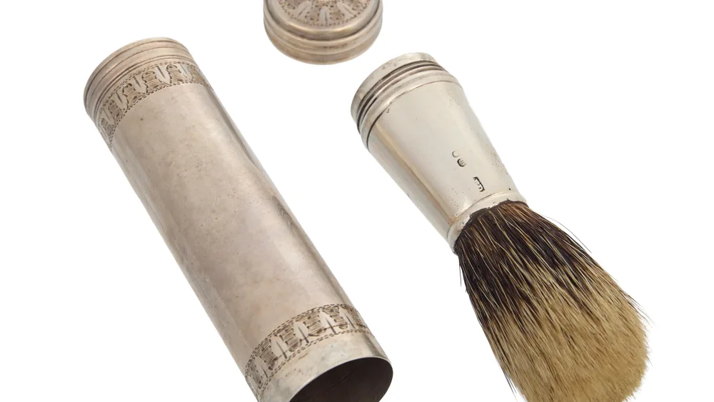 A silver shaving brush