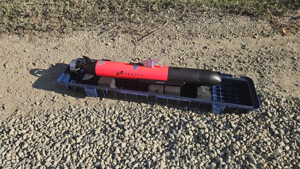 A small autonomous underwater vehicle sitting on a beach