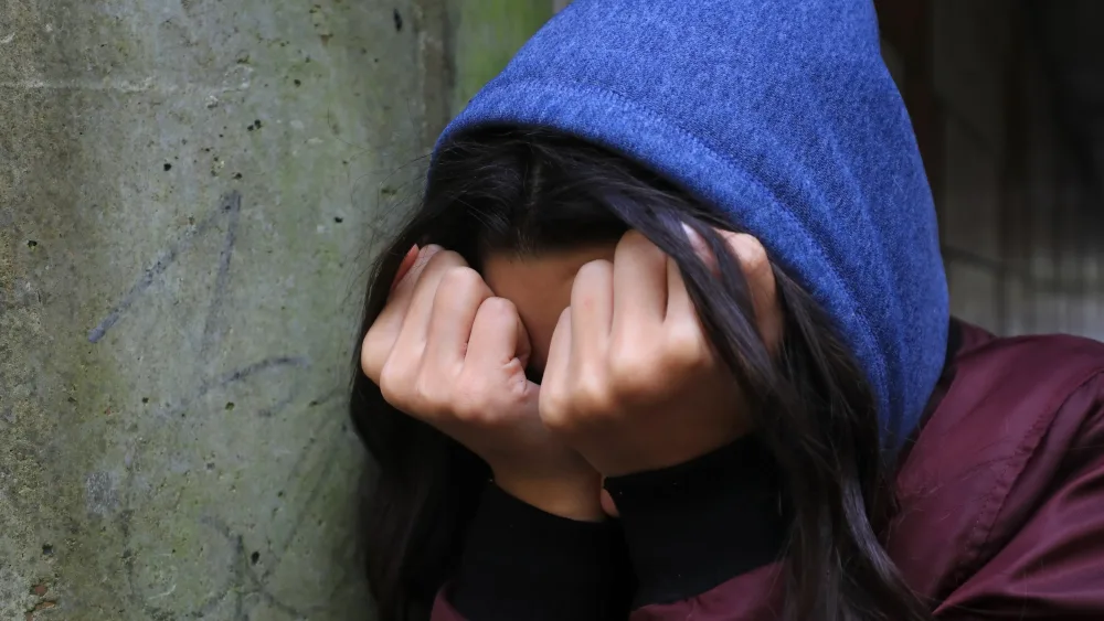 Model posing as distressed person