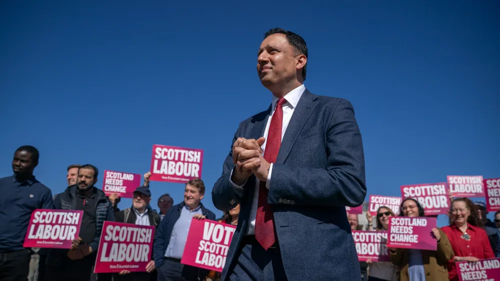 Anas Sarwar speaking in front of placard-waving Scottish Labour activists