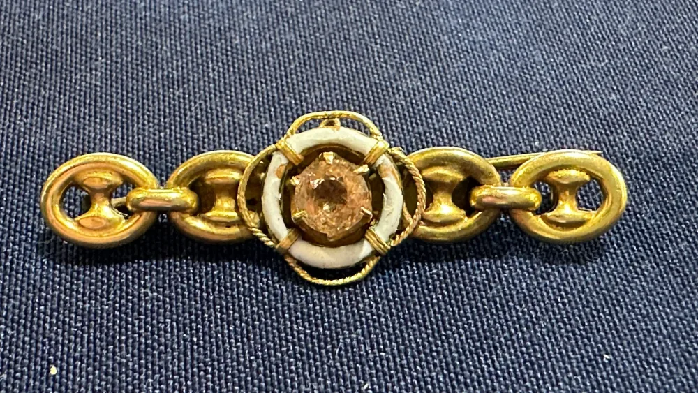 The brooch features a citrine stone surrounded by a life ring