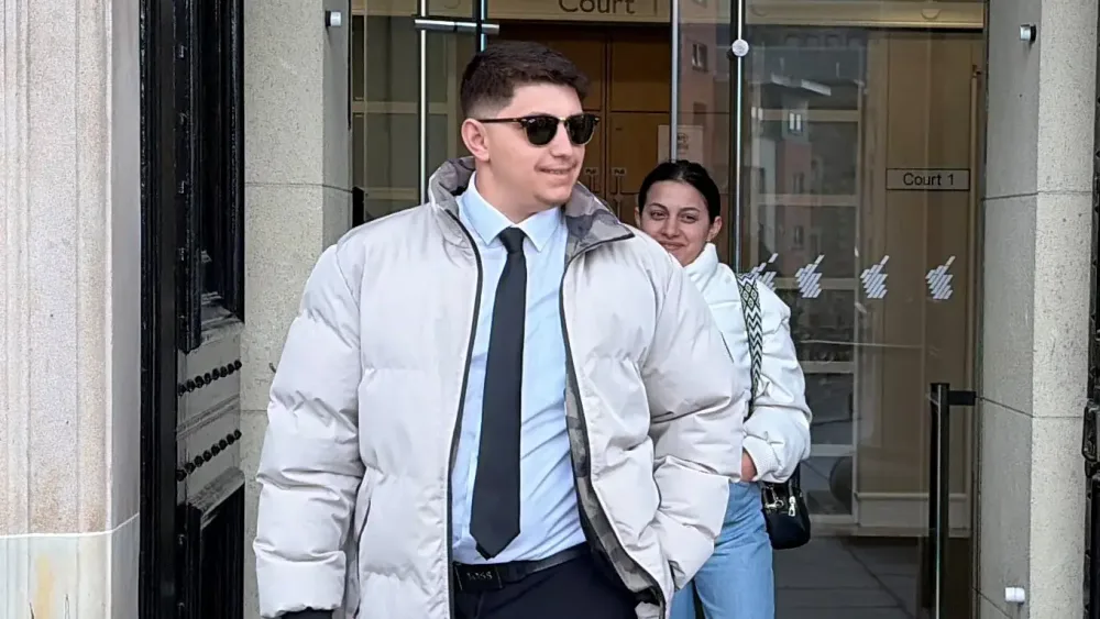 Ilia Belov and and Nadjedzha Belova walking out of a building