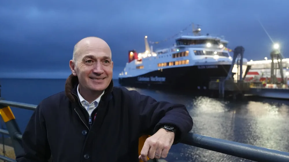 Duncan Mackison smiling while standing in front of the Glen Sannox