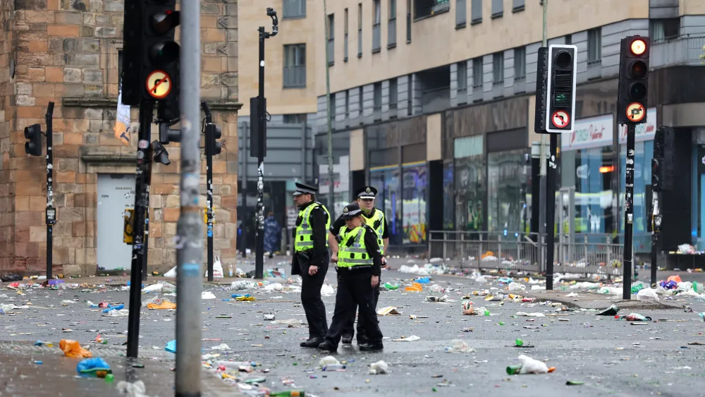 Police officers on the streets of Glasgow after Celtic won the William Hill Premiership title after a 3-1 win at home to Hearts