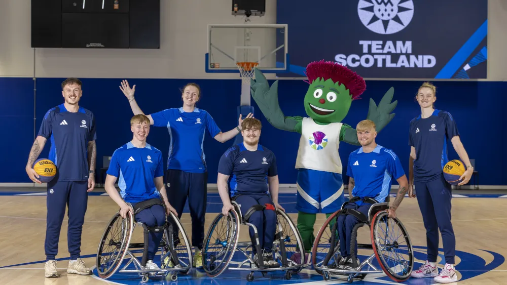Clyde mascot with members of Team Scotland in a gym hall