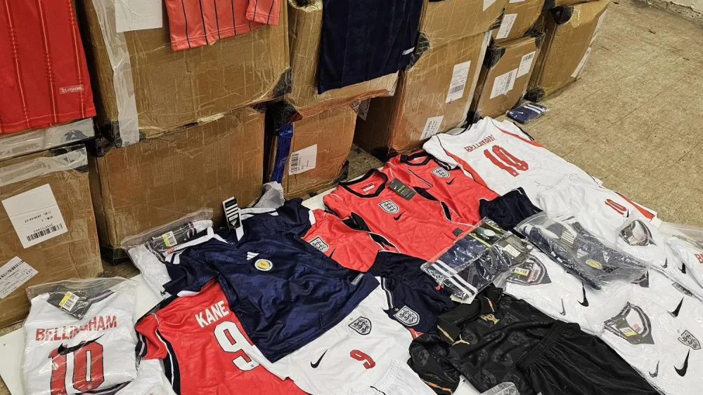 Counterfeit Scotland and England shirts lying on the floor, and on top of boxes