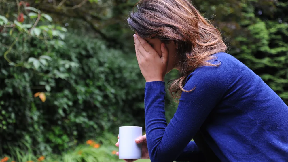 A woman with her head in her hands