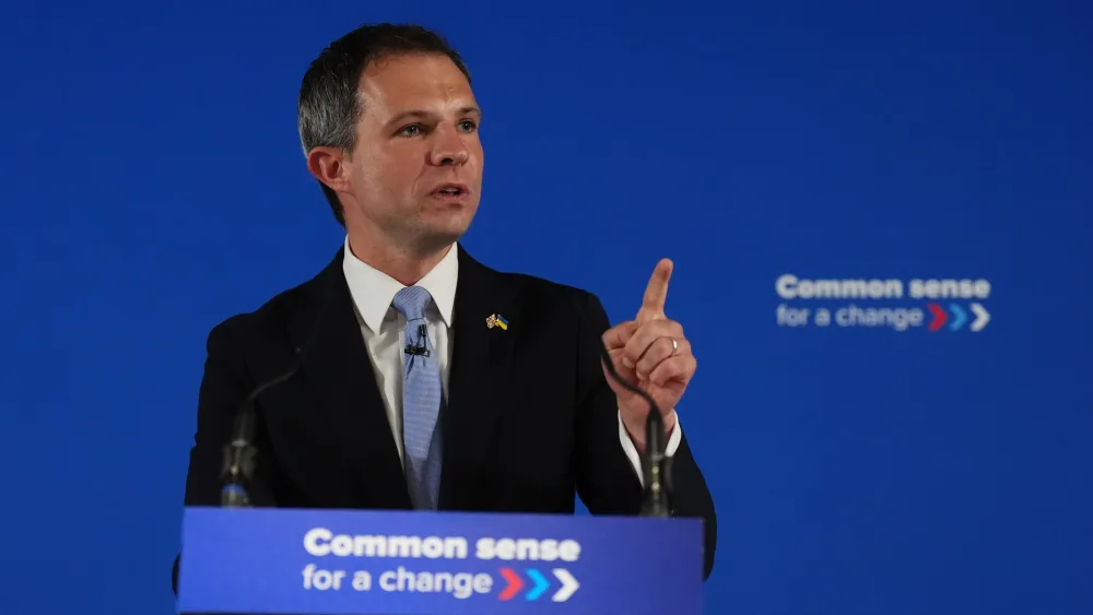 Andrew Bowie pointing while speaking from a Scottish Tory lectern