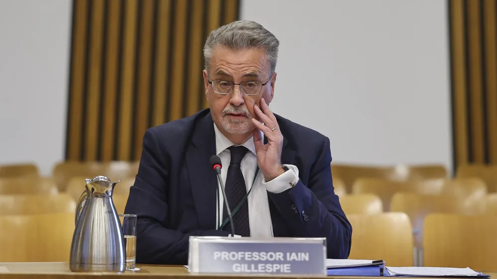 Professor Iain Gillespie seated in a Holyrood committee