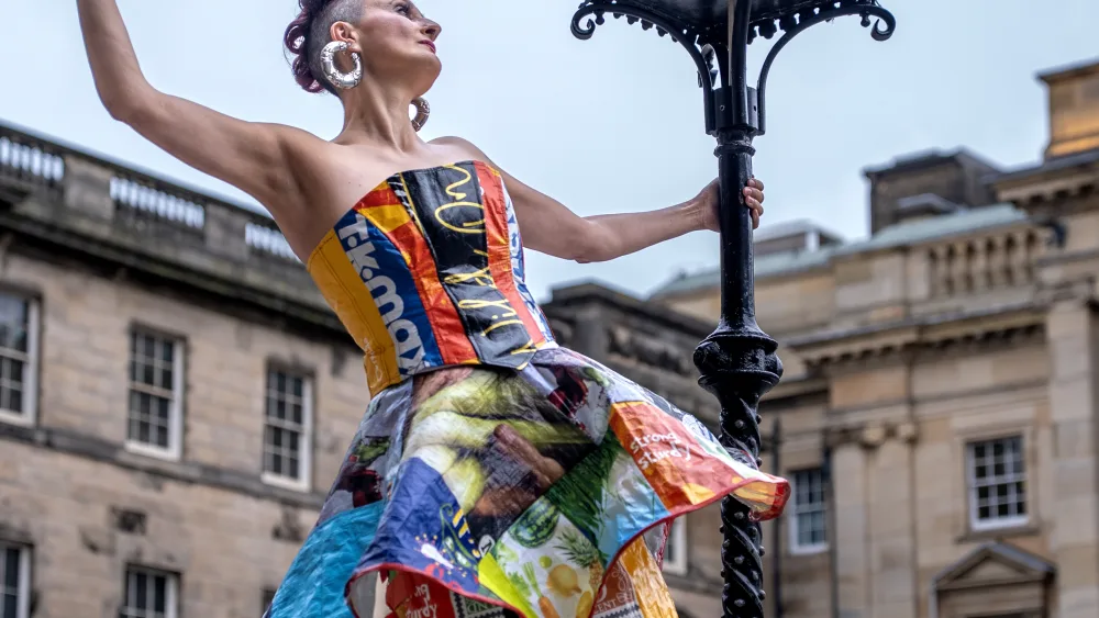 A woman wearing a dress created from bags-for-life