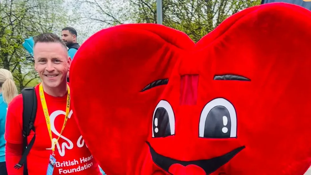 Neil Magill next to a British Heart Foundation mascot
