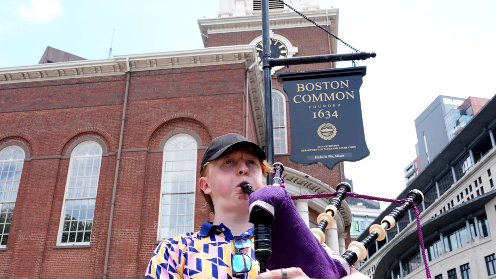 Scotland fan Simon Morley playing bagpipes outside Park Street Church in Boston