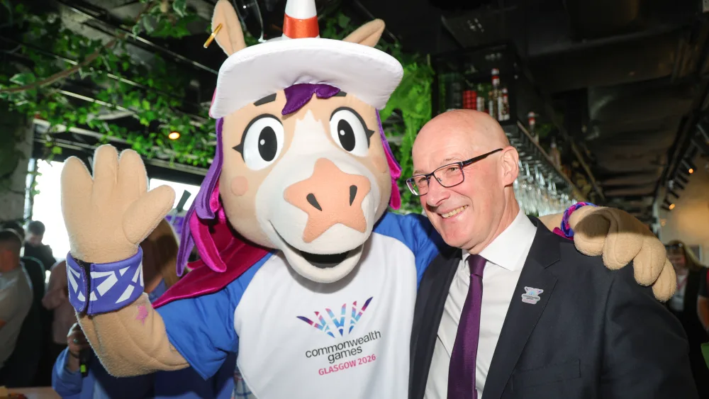 First Minister John Swinney with Finnie, the Commonwealth Games' mascot