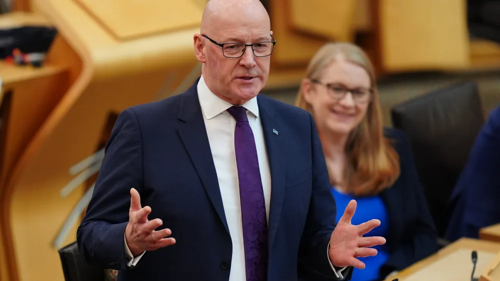 John Swinney standing while speaking in Holyrood
