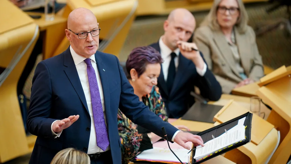John Swinney standing while speaking in Holyrood