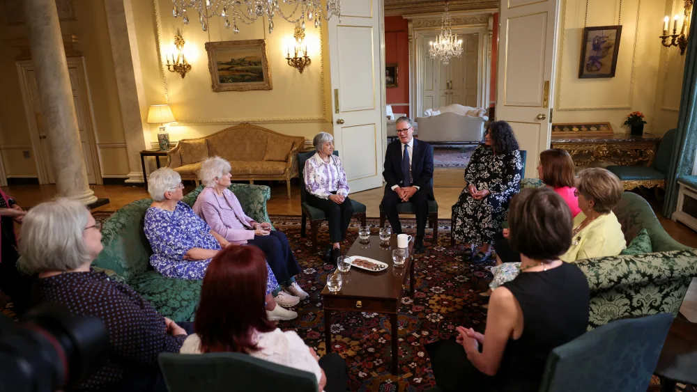 Sir Keir Starmer seated as part of a group within Downing Street