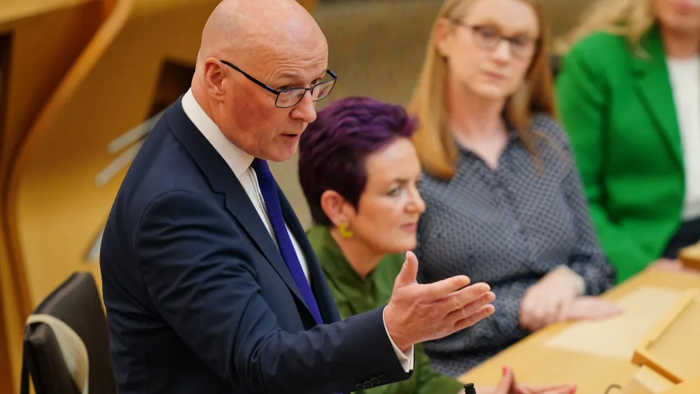 John Swinney standing while speaking in Holyrood