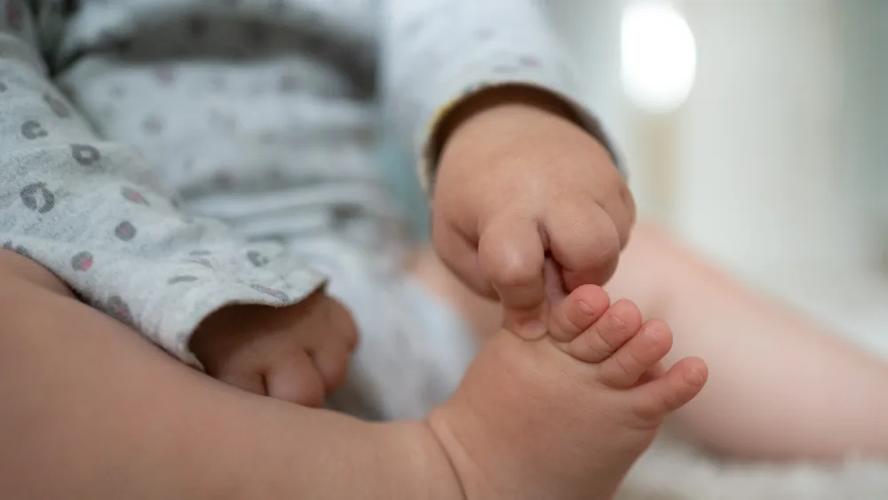 A baby touching its own toes