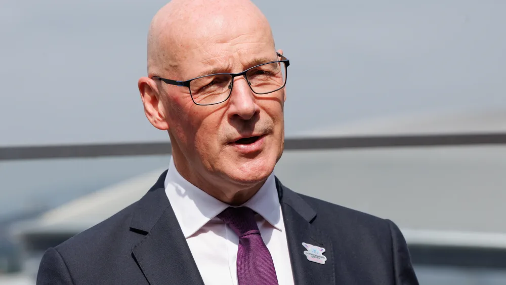 First Minister John Swinney speaks to gathered media