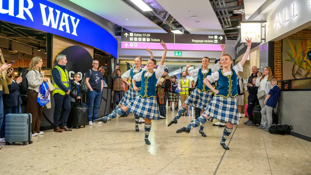 Highland dancers performing in an airport terminal