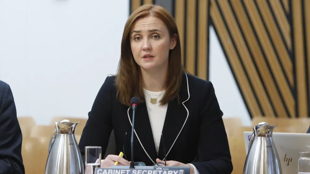 Mairi McAllan seated while speaking in Holyrood