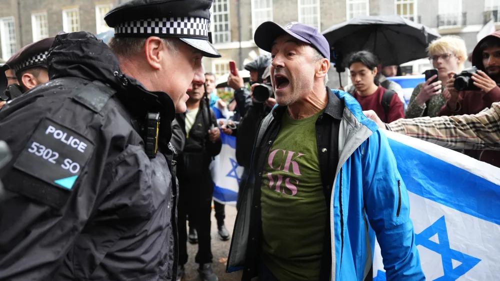 A police officer speaking to a counter-protester