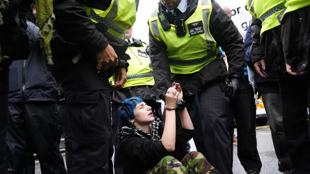 Police removing a person during a pro-Palestine march