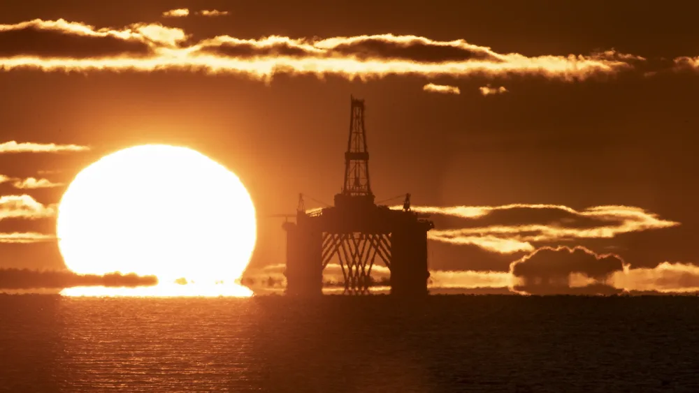 A sunset behind an oil rig