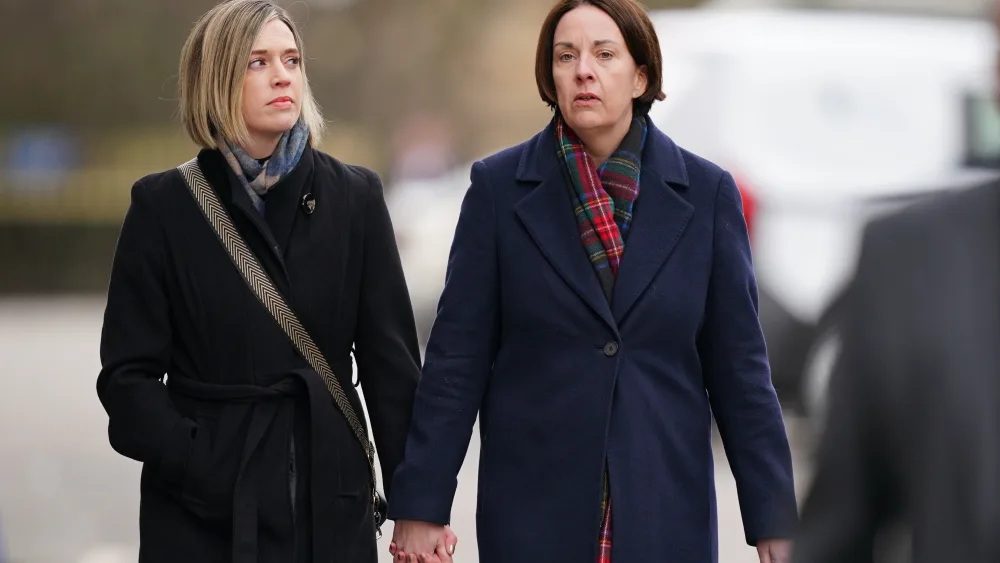 Jenny Gilruth and Kezia Dugdale holding hands while walking outside