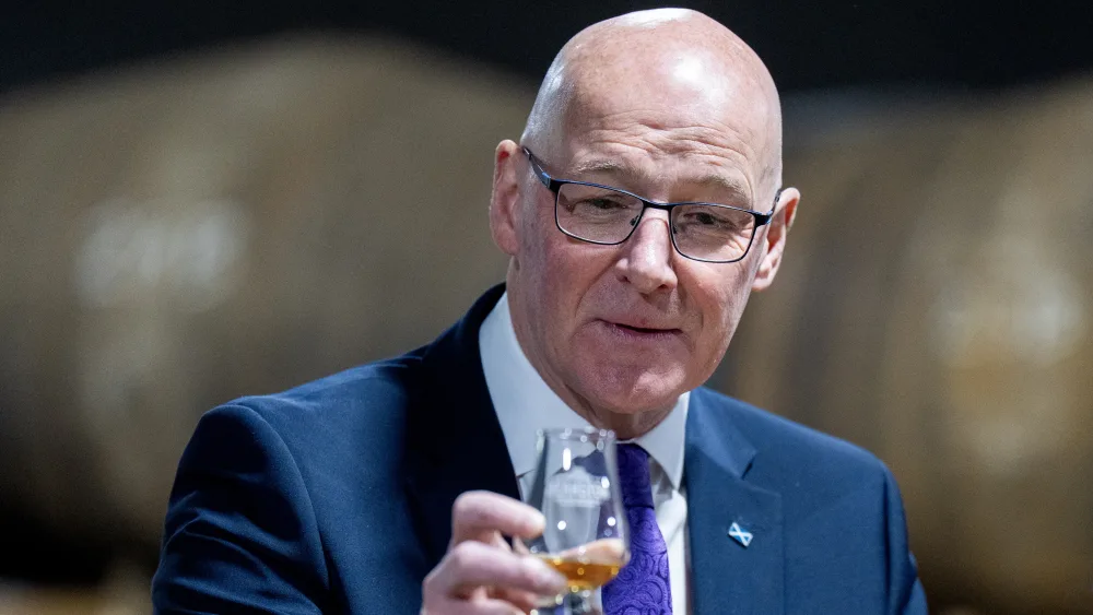 John Swinney with a glass of whisky