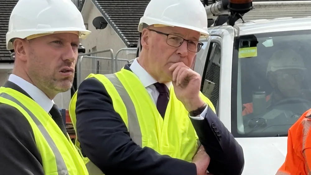 John Swinney wears a safety hat during a visit to Coalsnaughton