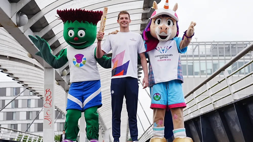 Duncan Scott with the Commonwealth mascots Clyde and Finnie next to him