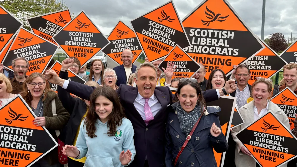 Alex Cole-Hamilton with his wife Gill and daughter Darcy surrounded by supporters