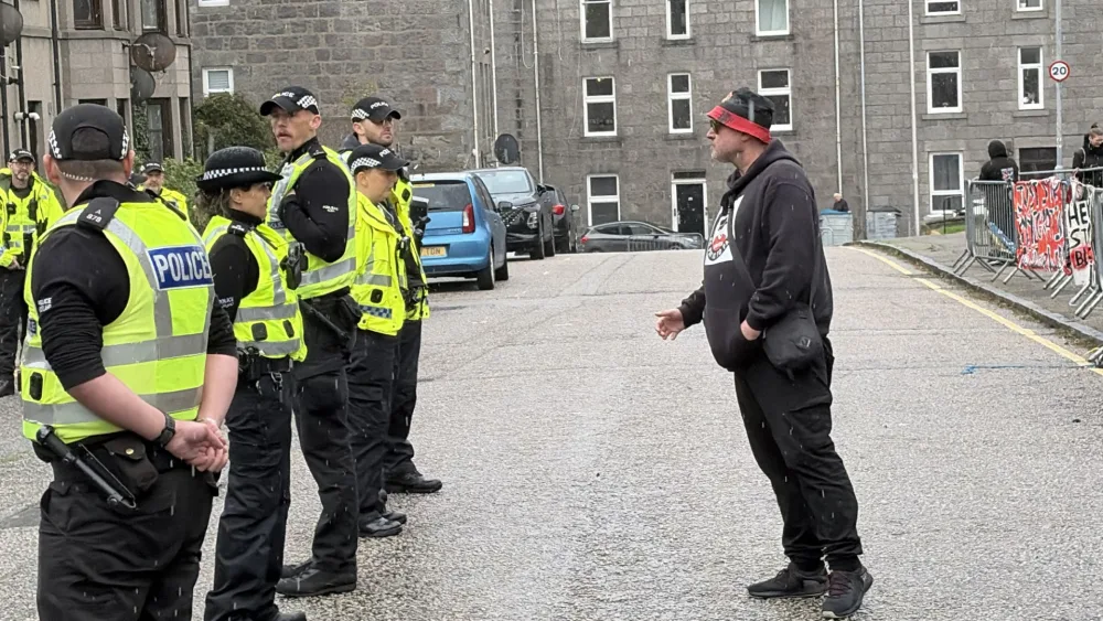 Man standing next to row of police officers