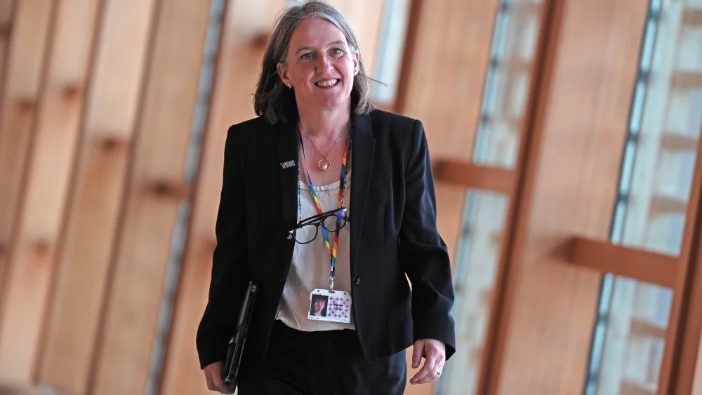 Maree Todd smiling while walking through a corridor at Holyrood