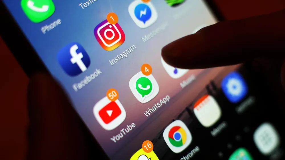 A finger pressing on a smartphone screen