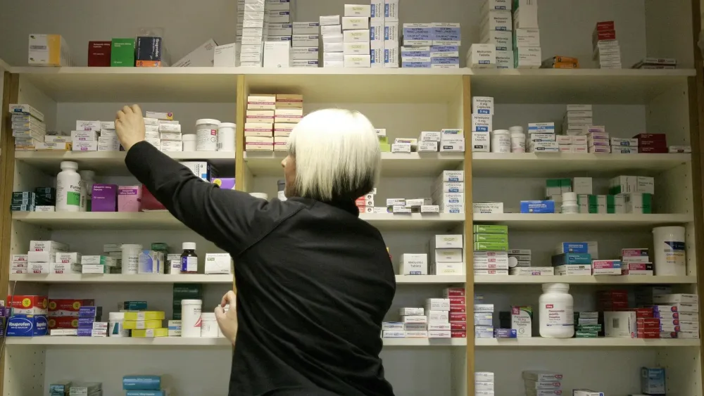 A pharmacist stocking shelves