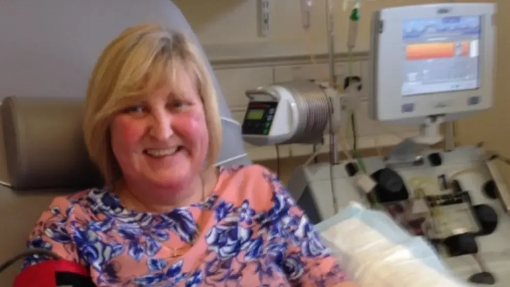 Sandra Watson smiling as she receives treatment in hospital