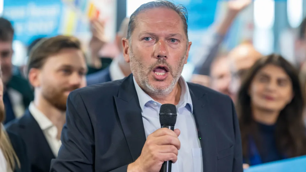 Aberdeen South MP Douglas Lumsden speaking into a microphone
