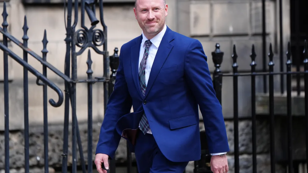 Neil Gray walking outside Bute House