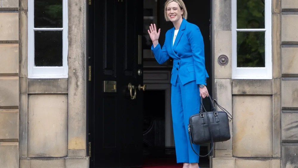 Jenny Gilruth waves to photographers