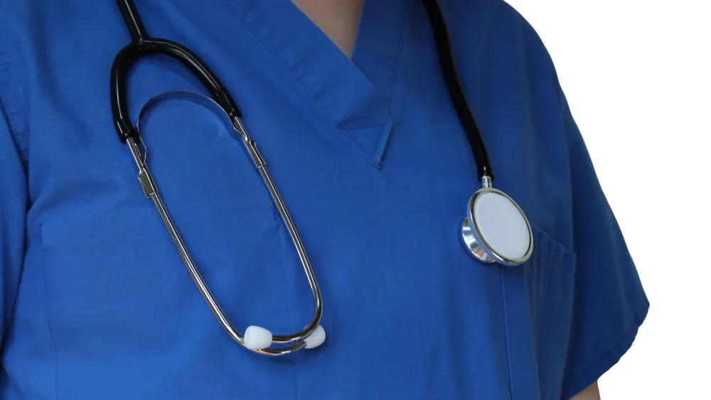 Closeup medical professional in blue scrubs with white background