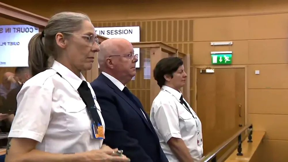 Peter Murrell in a courtroom surrounded by security guards