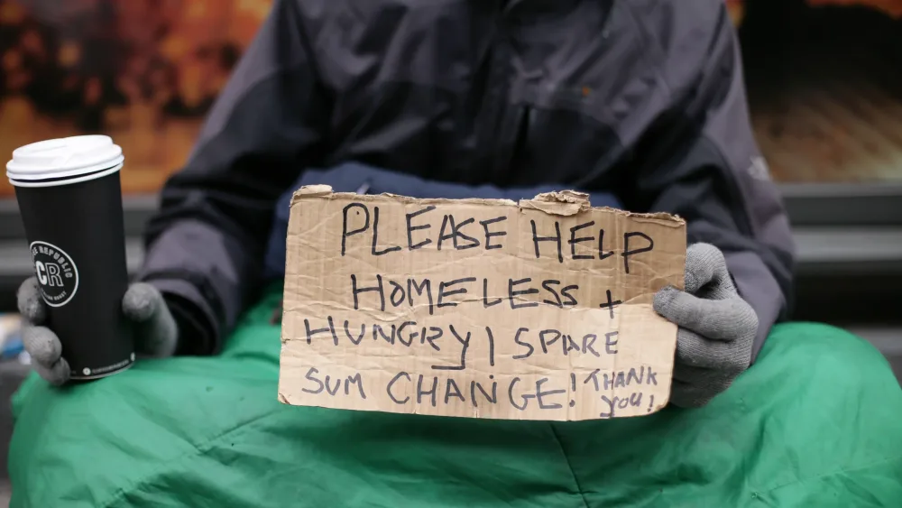 Homeless person with sign