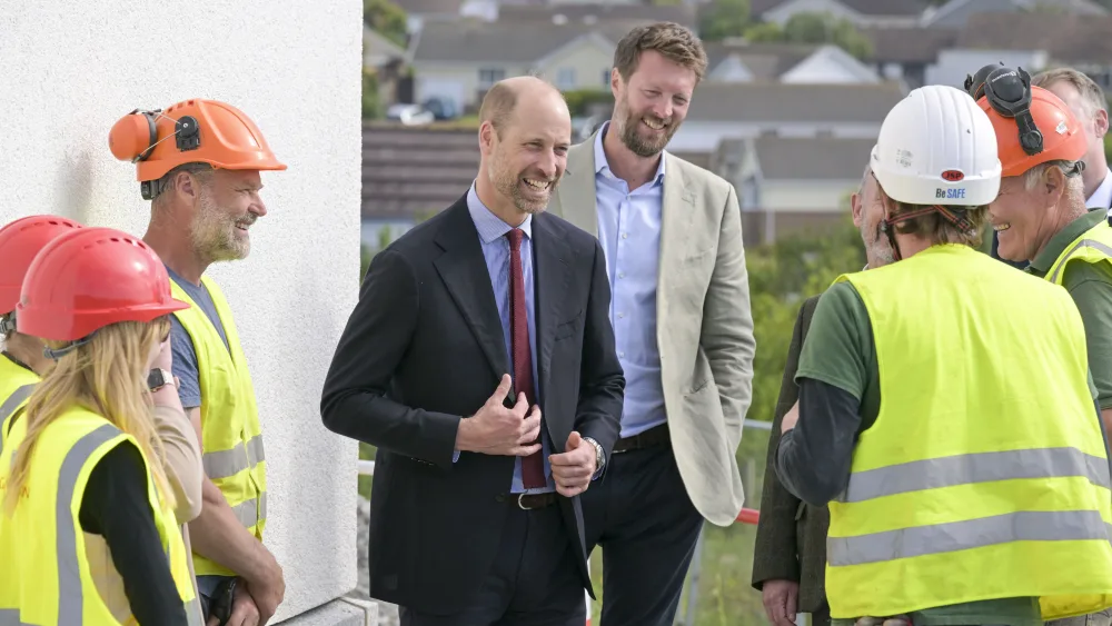 The Prince of Wales speaks with staff during a visit to a Duchy of Cornwall housing development in Tretherras, Cornwall, to mark the final stages of a project that includes homes purpose-built to address homelessness