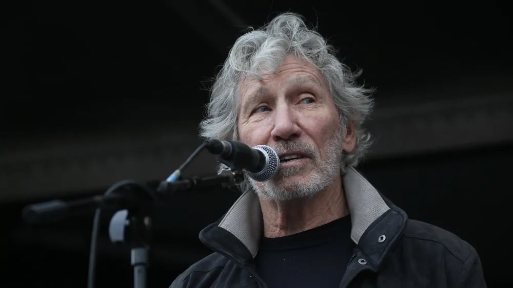 Rogers Waters speaks into a microphone