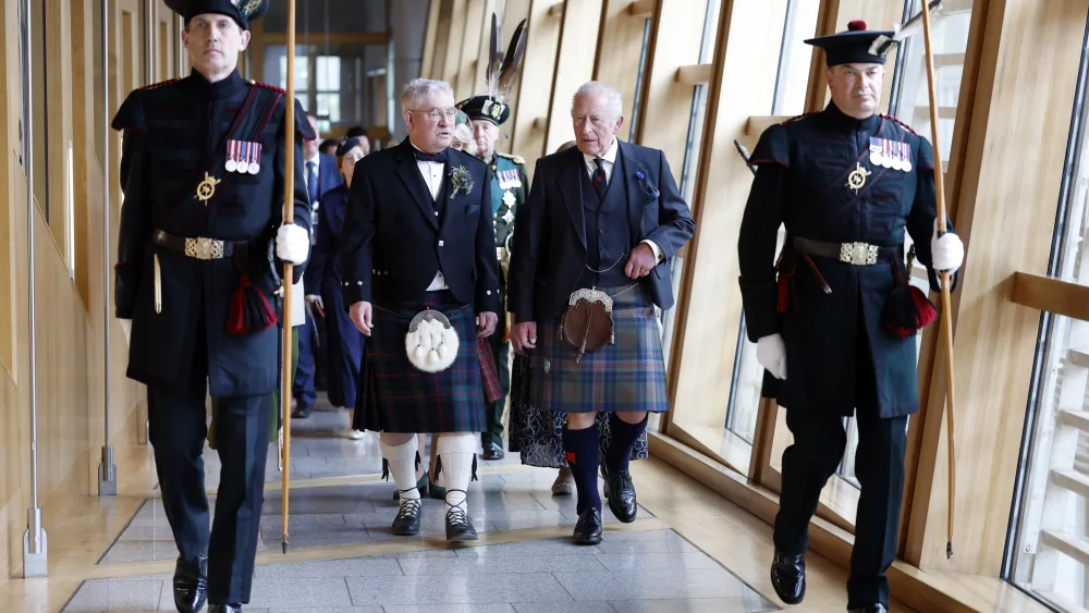 Charles is escorted by Presiding Officer Kenneth Gibson MSP as they arrive for the opening of the seventh session of the Scottish Parliament in Edinburgh