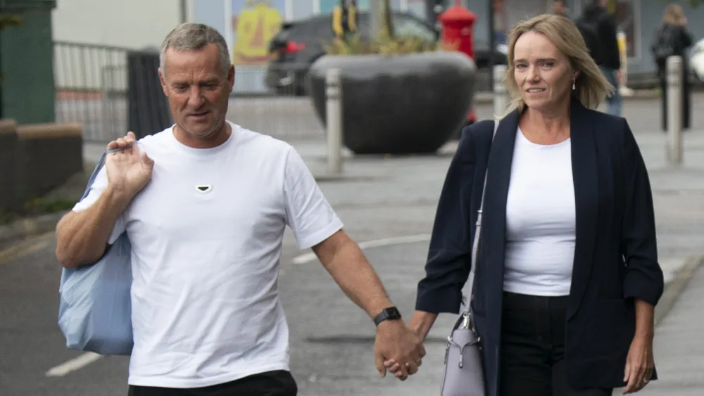 Sandie Peggie walking holding hands with her husband